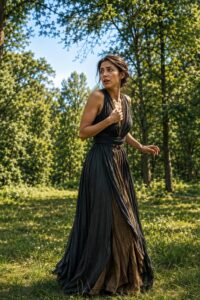 A frightened woman looks back in a peaceful forest in broad daylight, symbolizing an organism kept on high alert by cortisol despite the absence of danger.